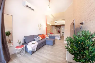 a living room with a blue couch in a room at NB - Cozy loft steps from City of Arts & Sciences in Valencia