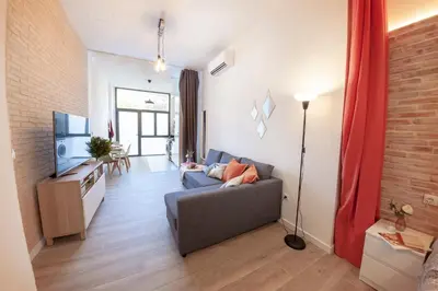 a living room with a couch and a television at NB - Cozy loft steps from City of Arts & Sciences in Valencia