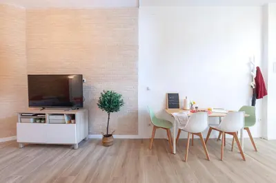 a living room with a table with chairs and a tv at NB - Cozy loft steps from City of Arts & Sciences in Valencia