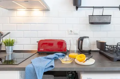 a kitchen counter with a red toaster and oranges on it at NC - Design Loft Steps from City of Arts & Sciences in Valencia
