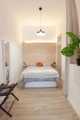 a bedroom with a bed and a potted plant at NC - Design Loft Steps from City of Arts & Sciences in Valencia