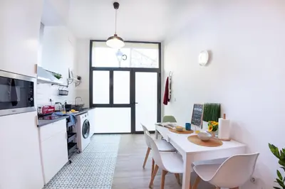 a kitchen and dining room with a table and chairs at NC - Design Loft Steps from City of Arts & Sciences in Valencia