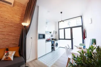 a small apartment with a kitchen and a living room at NC - Design Loft Steps from City of Arts & Sciences in Valencia