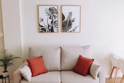 a living room with a couch and three pictures on the wall at Estelles D Apartment Close To Beach in Valencia