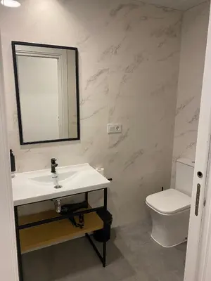 a bathroom with a sink and a toilet and a mirror at Cantalar White in Anna