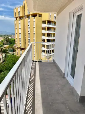 a balcony with a view of a building at Lowenva beach apartment in Canet de Berenguer