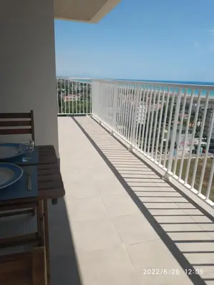 a balcony with a view of the ocean at Bonito apartamento con piscina cerca de la playa. in Canet de Berenguer
