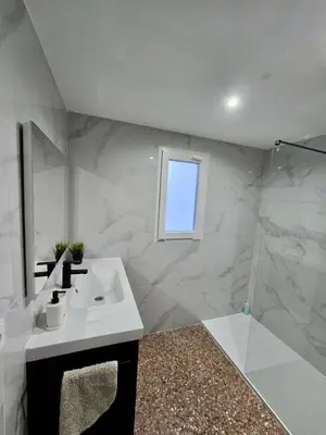 a bathroom with a sink and a shower at UIM Mediterraneo Isabel 23 Wifi in Puerto de Sagunto