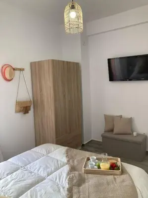 a bedroom with a tray of fruit on a bed at Coqueto Apartamento de Playa con Piscina y Terraza in Valencia