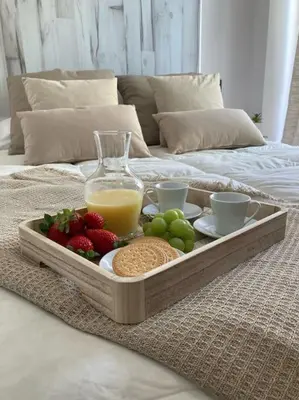 a tray of fruit and vegetables on a bed at Coqueto Apartamento de Playa con Piscina y Terraza in Valencia