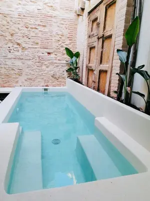 a swimming pool on the side of a building at Design house with swimming pool near the sea in Valencia