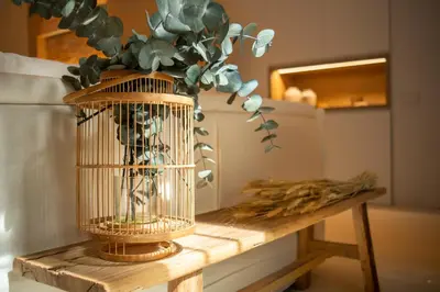 a bird cage with a plant in it on a table at Design house with swimming pool near the sea in Valencia