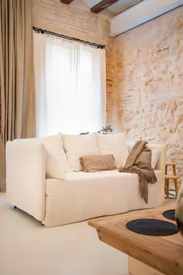 a white couch in a living room with a window at Design house with swimming pool near the sea in Valencia