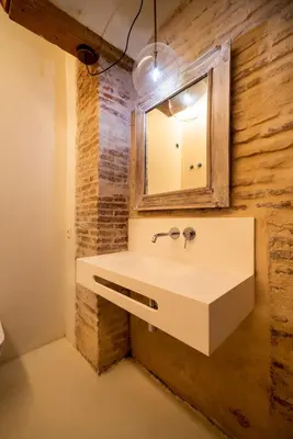 a bathroom with a sink and a mirror at Design house with swimming pool near the sea in Valencia