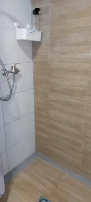 a bathroom with a shower with a wooden wall at Lyesblb in Valencia
