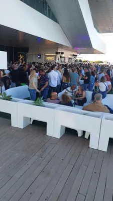 a large crowd of people sitting on white benches at Lyesblb in Valencia
