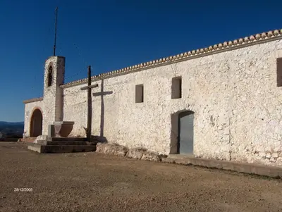 a building with a cross on the side of it at Apartamentos Rurales San Juan in Castellnovo