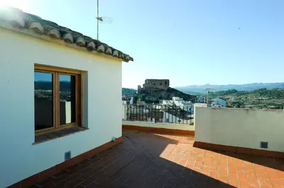 a balcony of a house with a view of a city at Apartamentos Rurales San Juan in Castellnovo