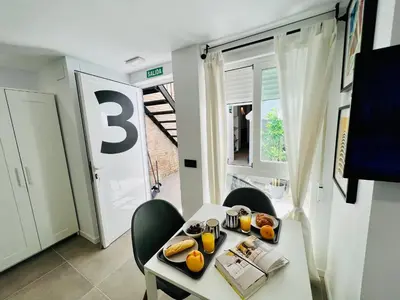 a room with a table and chairs with food on it at COOL LOFTS ALAMEDA VALENCIA in Valencia