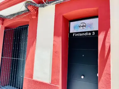 a red and white building with a black door at COOL LOFTS ALAMEDA VALENCIA in Valencia