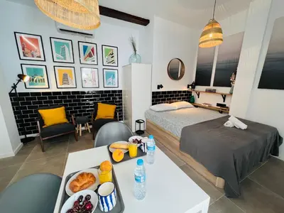 a bedroom with a bed and a table with food on it at COOL LOFTS ALAMEDA VALENCIA in Valencia