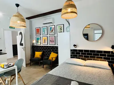 a bedroom with a bed and a table and a mirror at COOL LOFTS ALAMEDA VALENCIA in Valencia