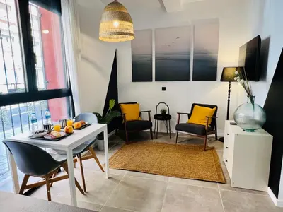 a living room with a table and chairs at COOL LOFTS ALAMEDA VALENCIA in Valencia