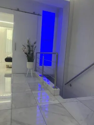 a staircase with blue lights in a white room at DeLuxe House Valencia in Valencia