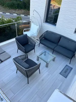 a patio with a couch and chairs and a table at DeLuxe House Valencia in Valencia