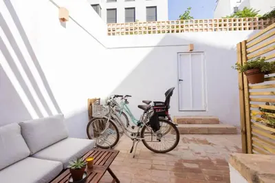 a bike parked on a patio next to a couch at Casa Valenciana con Terraza in Valencia