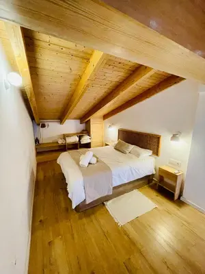 a bedroom with a large bed and wooden ceilings at Casa Valenciana con Terraza in Valencia