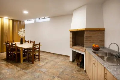 a kitchen with a table and a dining room at Torre Buen Aire cerca de Valencia, con jacuzzi y barbacoa in Benafer