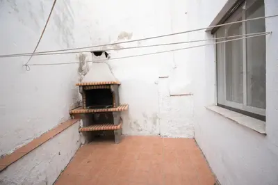 an empty room with a heater in the corner of a building at El Maestro in Caudiel