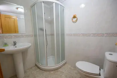 a bathroom with a shower and a toilet and a sink at El Maestro in Caudiel