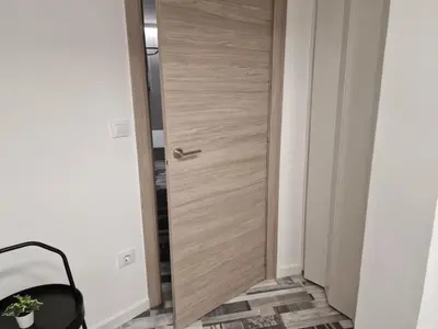 a wooden door in a room with a chair at Selena Beach in Cullera