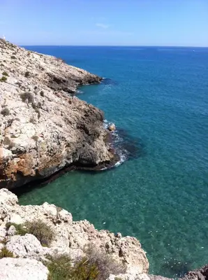 an aerial view of the ocean on a rocky coast at Selena Beach in Cullera