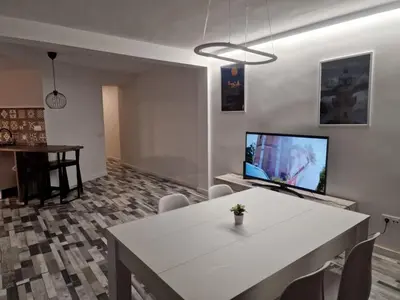 a living room with a white table and a tv at Selena Beach in Cullera