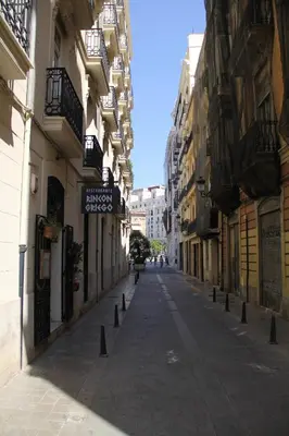 an empty street in a city with buildings at City Centre Room in Valencia
