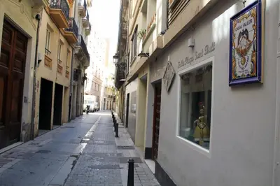 an empty street in an alley with buildings at City Centre Room in Valencia