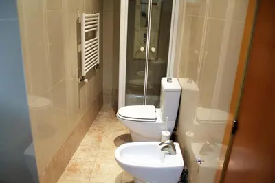 a bathroom with a toilet and a glass shower at City Centre Room in Valencia
