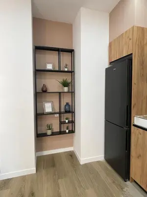 a kitchen with a black refrigerator in a room at UIM Mediterraneo PB Luis Vives Wifi in Puerto de Sagunto