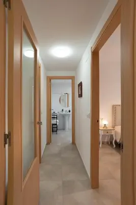 a hallway with an open door to a room at Nuevo y moderno apartamento con aire acondicionado - El Cid 4 in Burriana