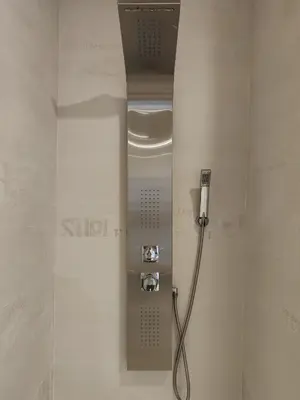 a shower in a bathroom with a hose on the wall at The Luxury Apartment in Valencia