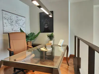 a glass table and a chair in a room at The Luxury Apartment in Valencia