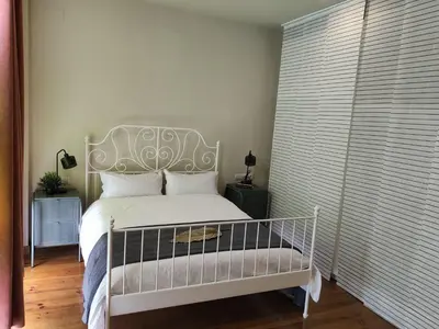 a bedroom with a white bed with a white headboard at The Luxury Apartment in Valencia
