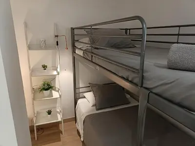 a bedroom with two bunk beds and a small bed at Holiday Hanna’s House in Valencia