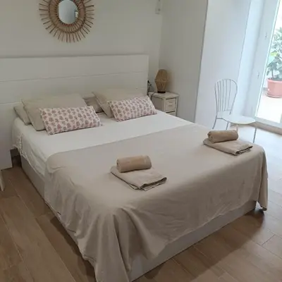 a bedroom with a large bed with two pillows on it at Holiday Hanna’s House in Valencia