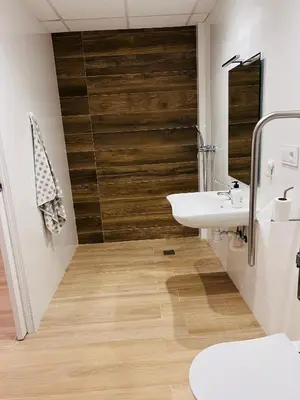 a bathroom with a sink and a wooden wall at Holiday Hanna’s House in Valencia