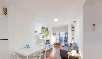 a white living room with a table and a couch at Apartamento Centro Histórico Valencia de 2 habitaciones in Valencia