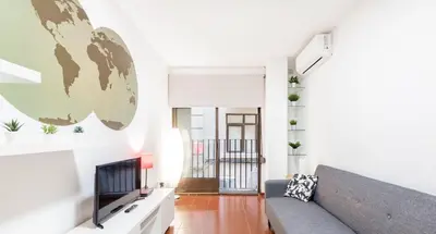 a living room with a couch and a television at Apartamento Centro Histórico Valencia de 2 habitaciones in Valencia
